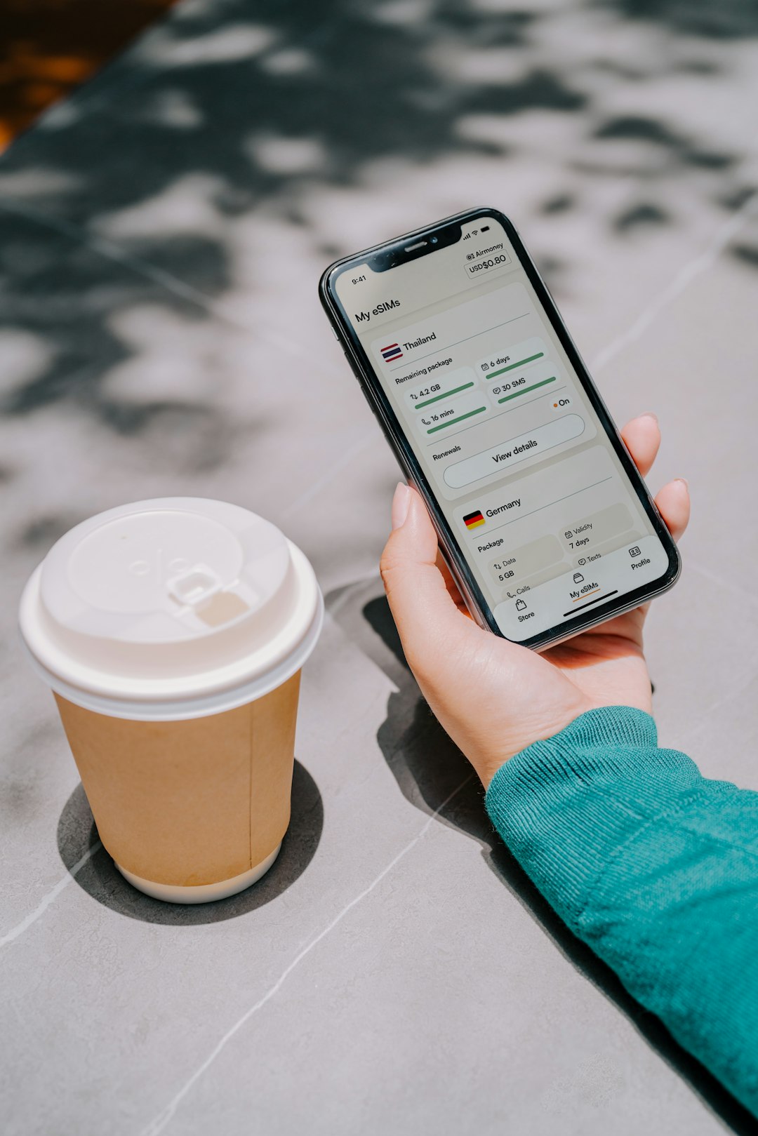 Traveler staying connected with an eSIMs on their iPhone device